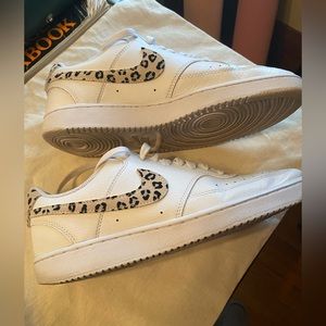 White with leopard swoosh Nike kicks